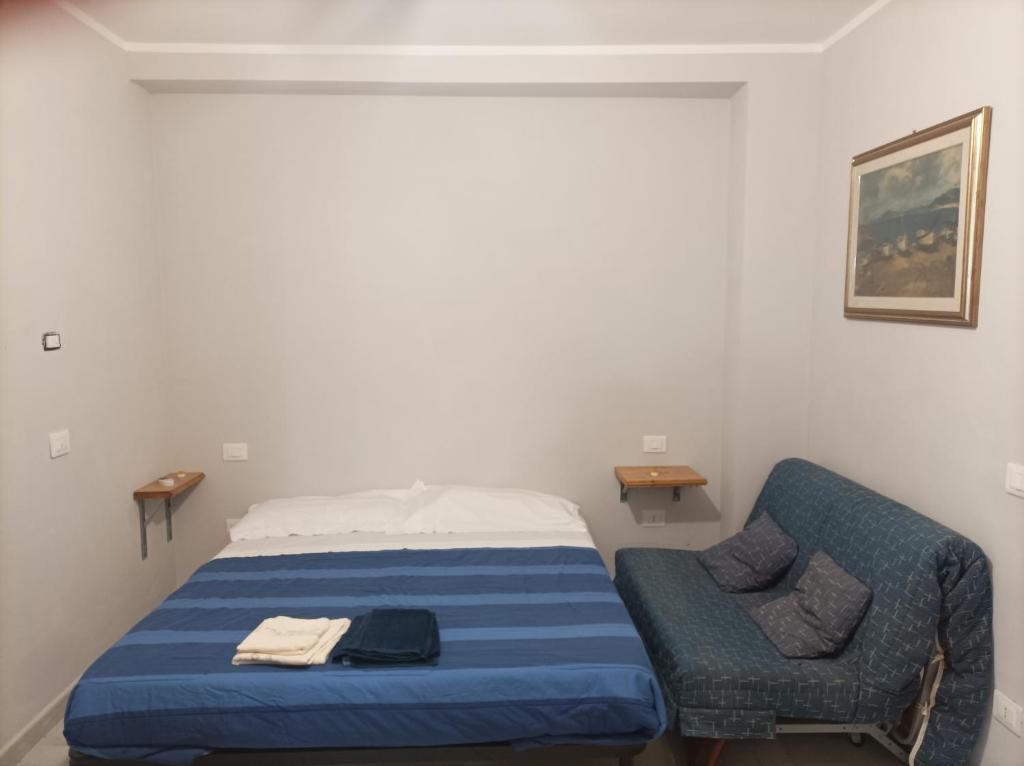 a small bedroom with a bed and a chair at Valery AffittaCamere in Capannori