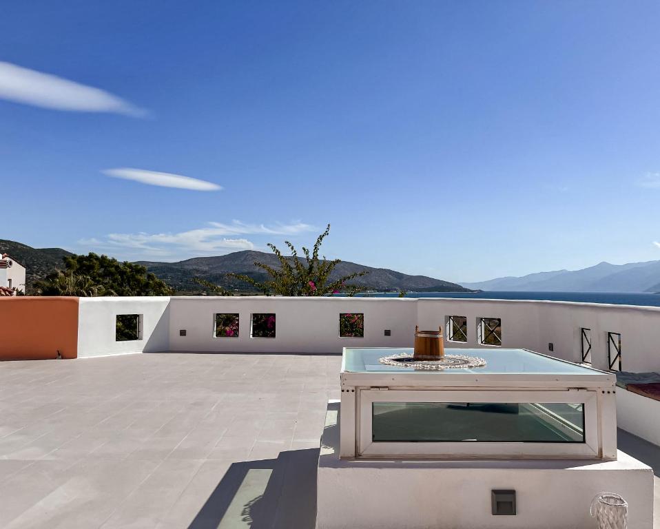 a table on the roof of a house at Nisea Hotel Samos in Pythagoreio