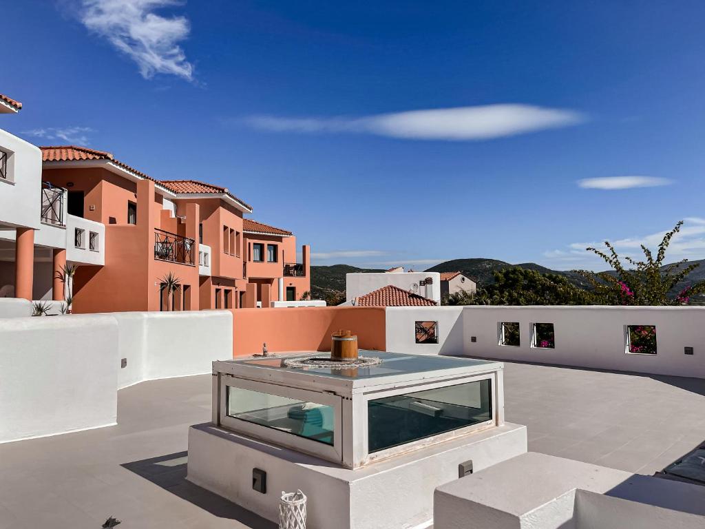 a glass house on the roof of a building at Nisea Hotel Samos in Pythagoreio