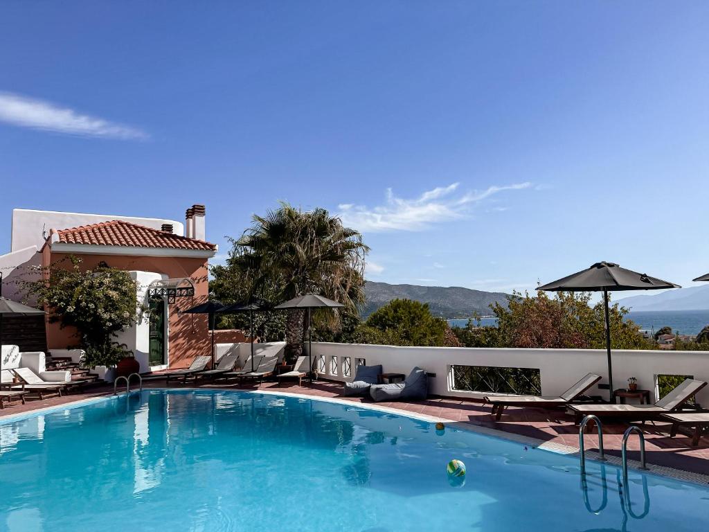 a swimming pool with chaise lounge chairs and a swimming pool at Nisea Hotel Samos in Pythagoreio
