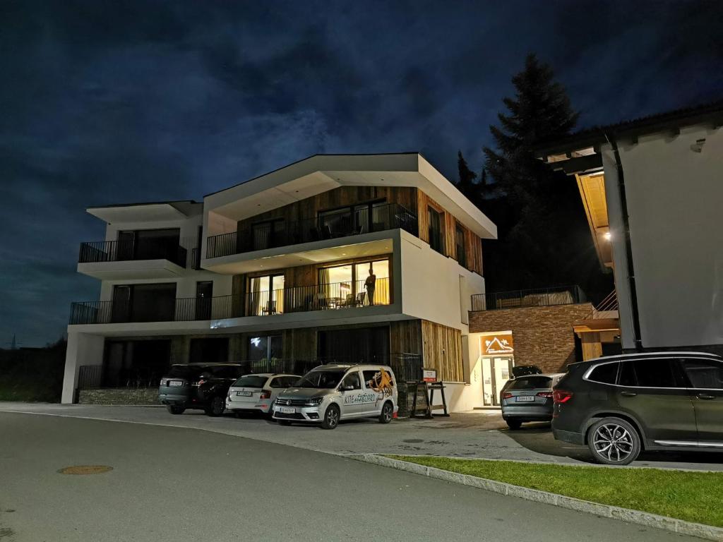 a large building with cars parked in front of it at Appartement Kitzsteinhorn -Summercard included in Kaprun