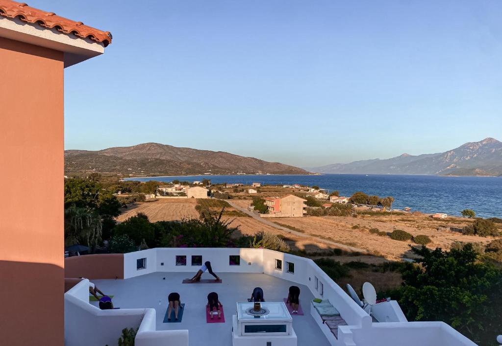 a group of people standing on a building overlooking the water at Nisea Hotel Samos in Pythagoreio