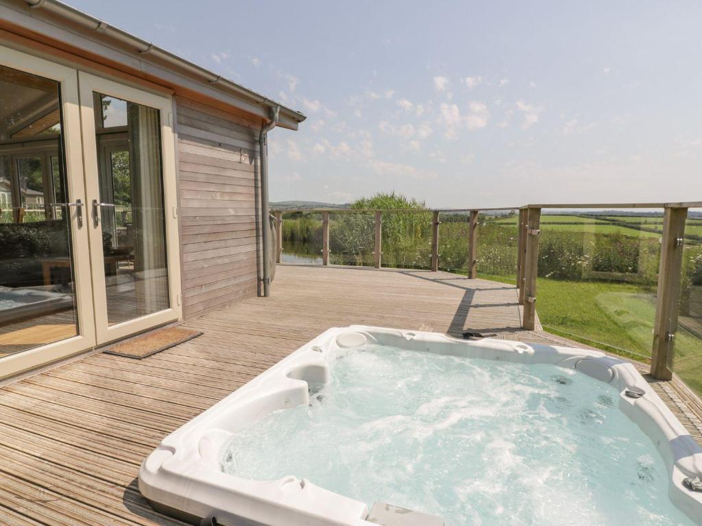 a hot tub on the deck of a house at 15 Faraway Fields in Liskeard