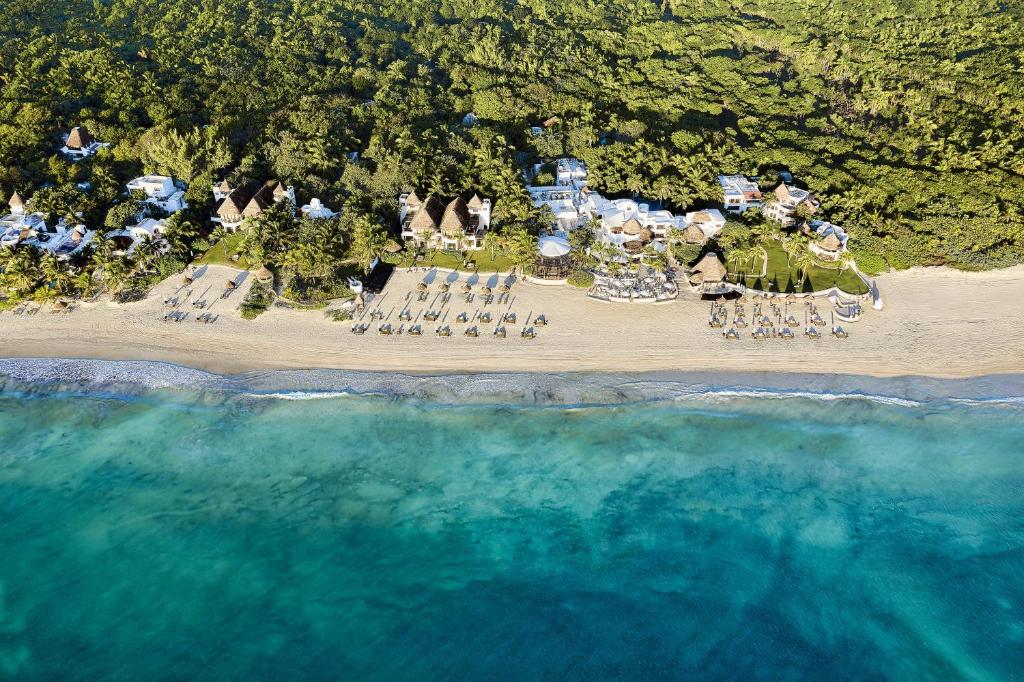 an aerial view of a beach with chairs and a resort at Maroma, A Belmond Hotel, Riviera Maya in Puerto Morelos