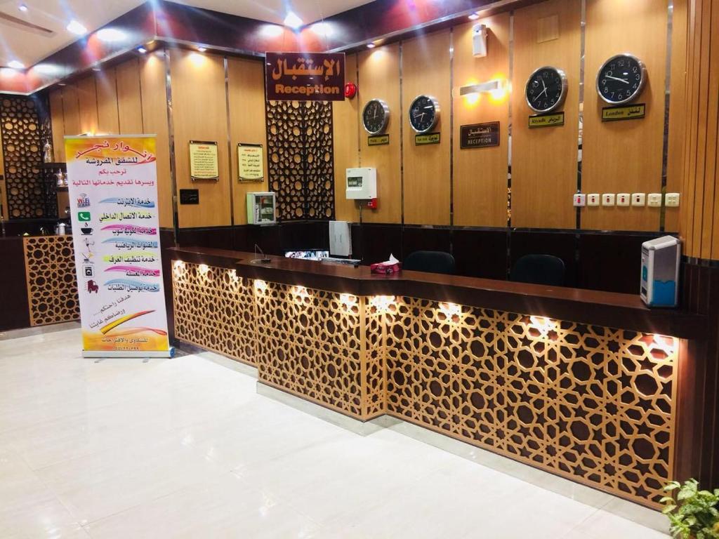a row of stalls in a room with a counter at أنوار نجد للشقق الفندقية in Riyadh
