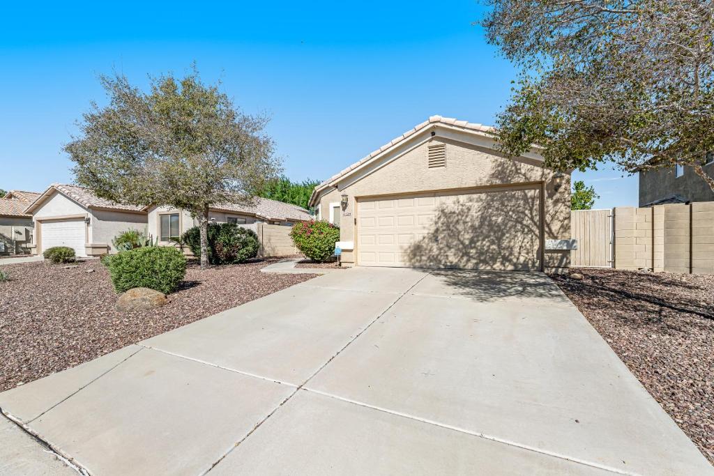 a house with a driveway and a garage at Good Times in Goodyear in Goodyear