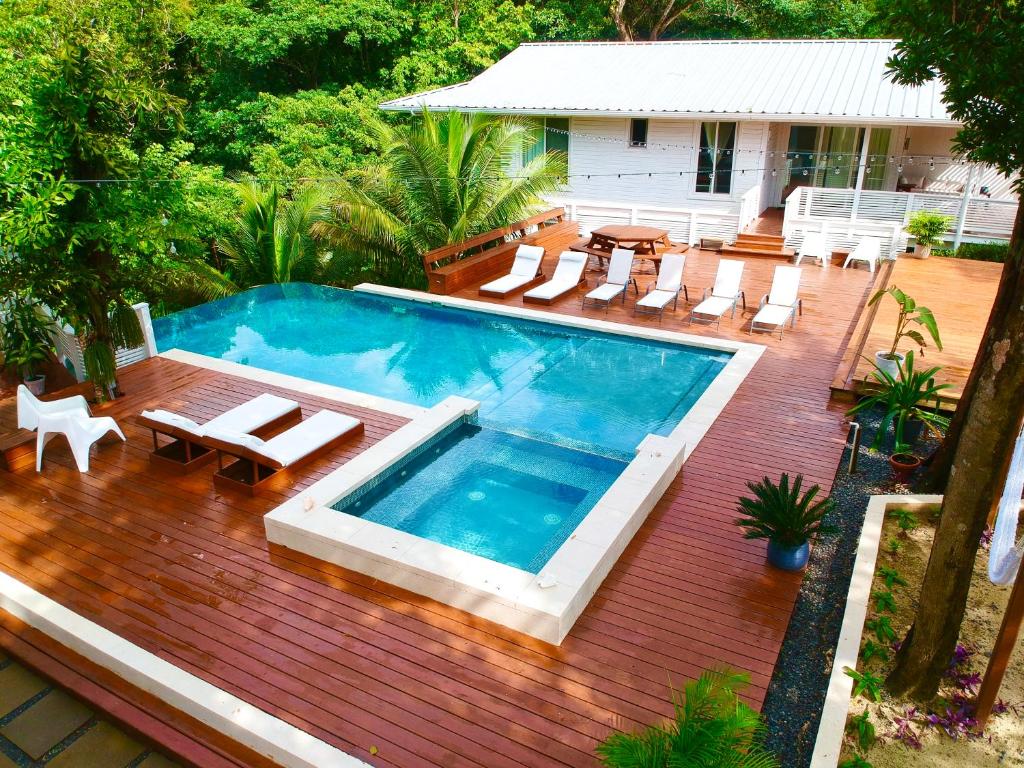 an overhead view of a swimming pool on a wooden deck at New One Bedroom Suite West Bay Roatan - Number 6 in West Bay