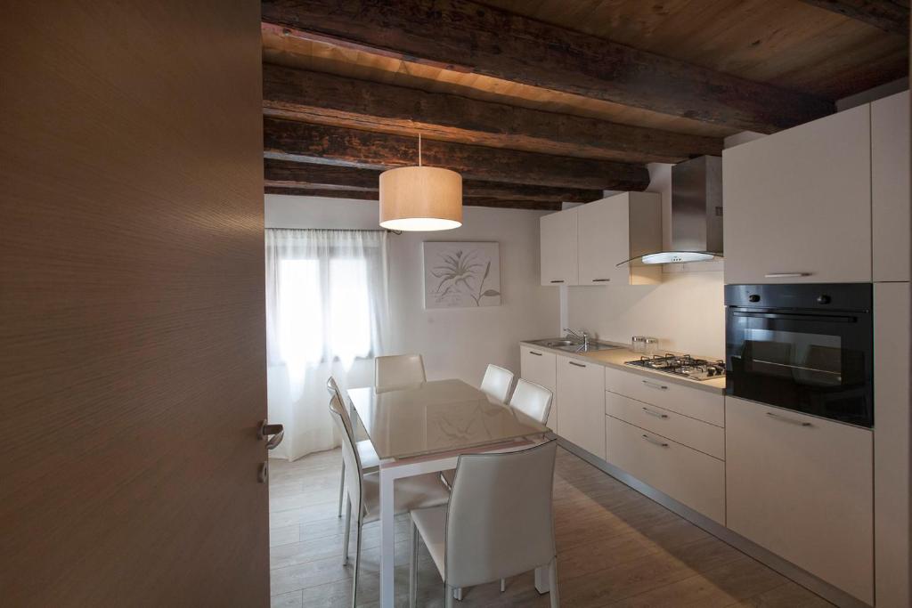 a kitchen with a table and chairs in a room at Residenza Tiziano in Venice