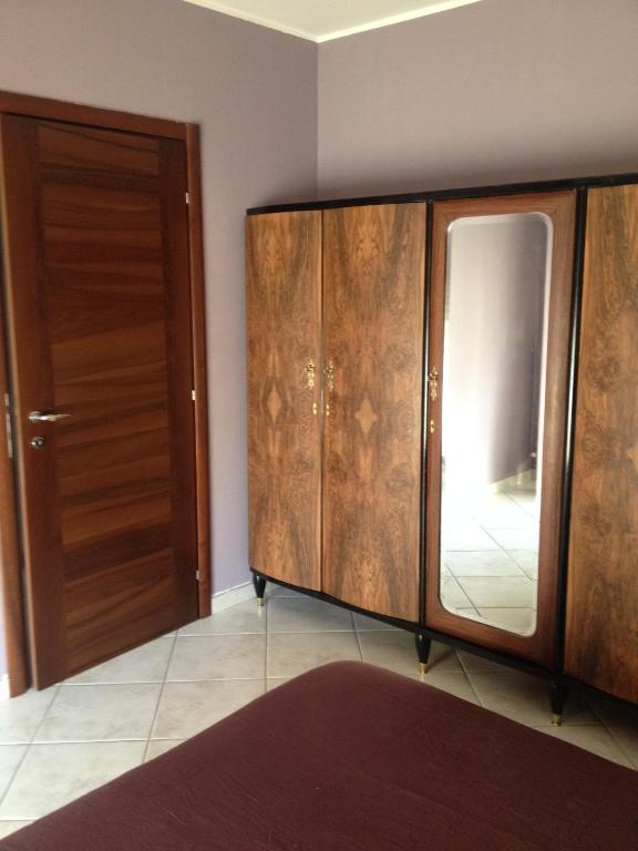 a kitchen with wooden cabinets and a door at Via Roma suite in Ortona