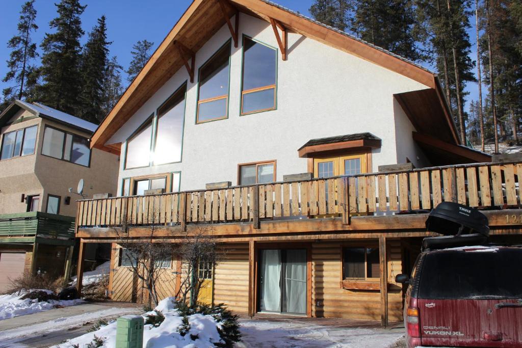a house with a deck on the side of it at A Gem Inn the Rockies in Jasper