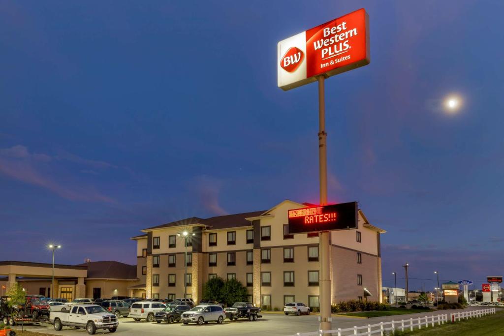 un panneau indiquant un hôtel avec des voitures garées dans un parking dans l'établissement Best Western Plus North Platte Inn & Suites, à North Platte