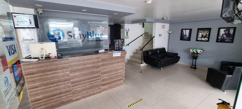 a hair salon with a counter and a black chair at Stay Blue Hotel in Bogotá