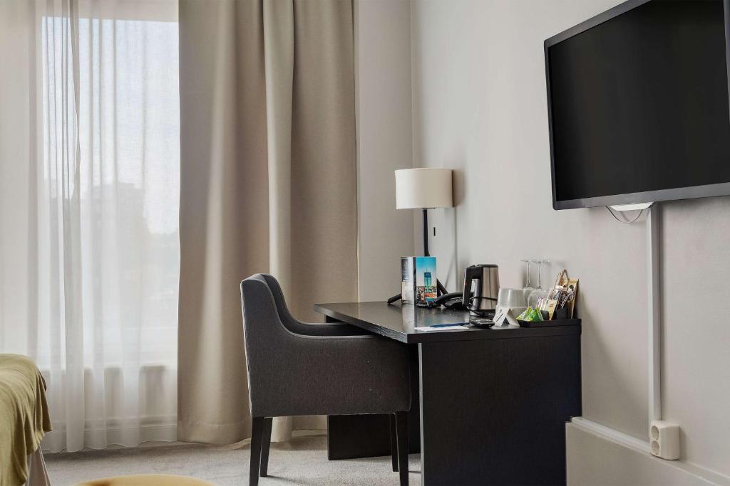 TV a/nebo společenská místnost v ubytování Best Western Plus Hotel Plaza