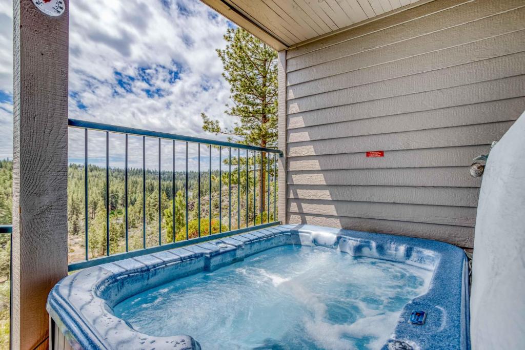 a hot tub on the balcony of a house at River Ridge 332AB in Bend
