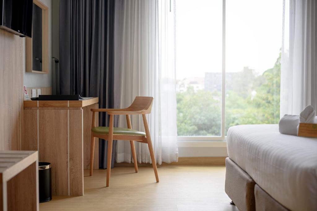 Postel nebo postele na pokoji v ubytování Prime Square Hotel