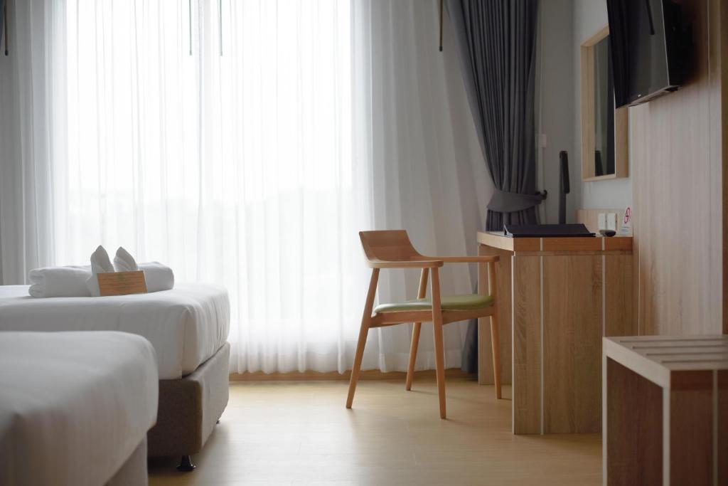 Postel nebo postele na pokoji v ubytování Prime Square Hotel