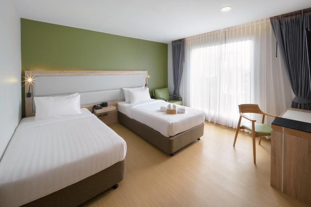Postel nebo postele na pokoji v ubytování Prime Square Hotel