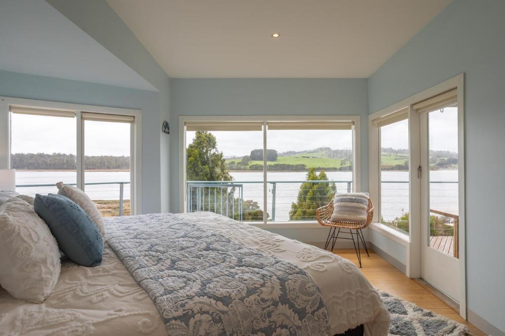 - une chambre avec un lit et une vue sur l'eau dans l'établissement Smuggler's Hideaway, riverfront Tamar Valley, à Blackwall