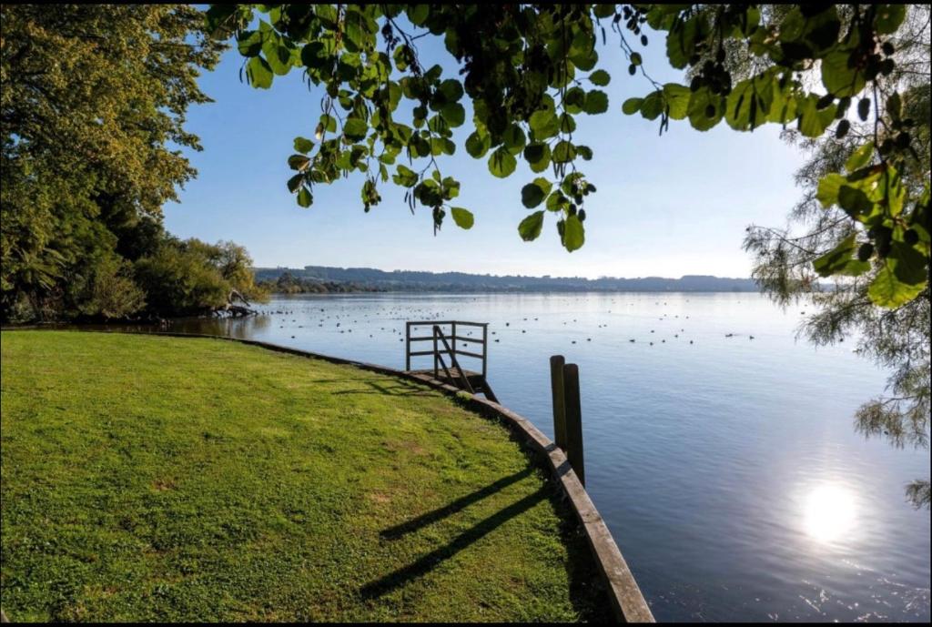 a view of a body of water with a dock at Lakeside & Tennis Court Paradise in Rotorua