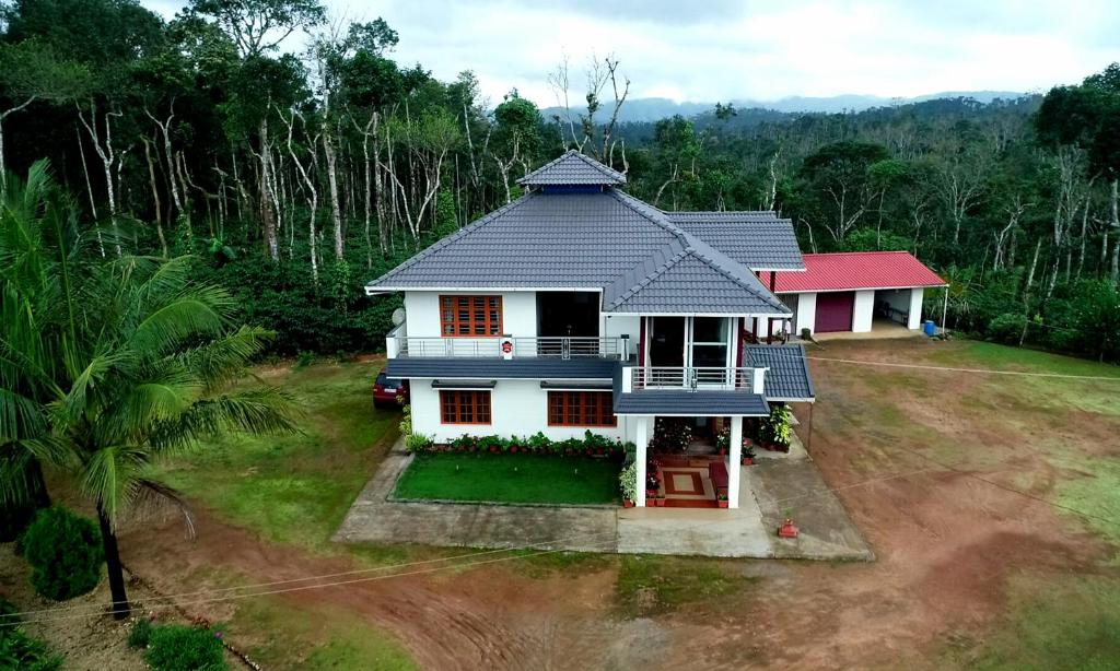 an aerial view of a house in a forest at Estate Flora Homestay - Balcony, Home Food, Coffee Estate in Sakleshpur