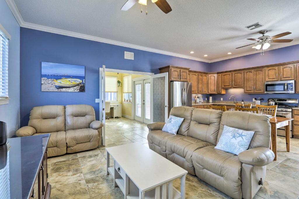 a living room with a couch and a table at The Shell House with Pool and Golf Access! in Titusville