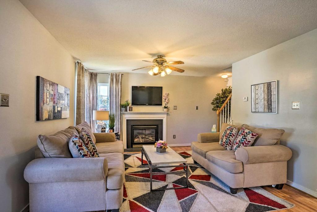 a living room with two couches and a fireplace at Charming Sandston Home about 9 Mi to Richmond! in Sandston