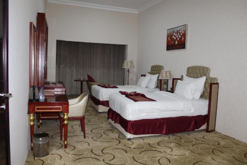 Postel nebo postele na pokoji v ubytování Al Salam Grand Hotel