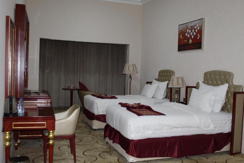 Postel nebo postele na pokoji v ubytování Al Salam Grand Hotel
