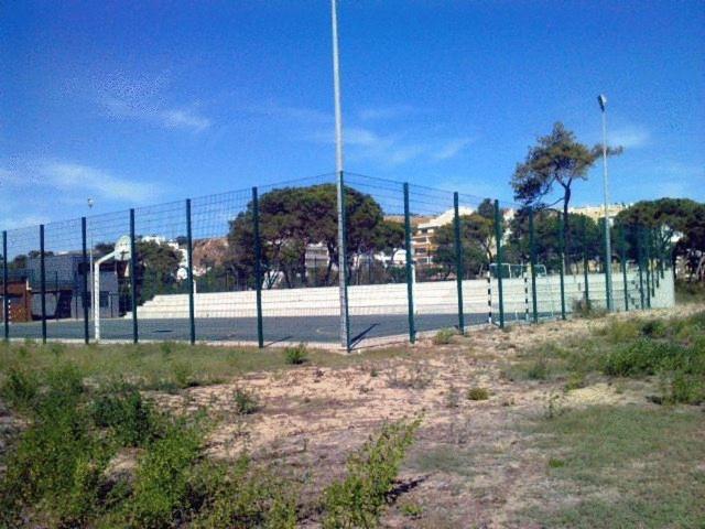 a chain link fence in front of a street at Hotel Residencial Colibri in Costa da Caparica