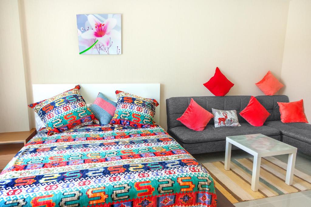 a living room with a bed and a couch at Nai Thon Condo Unit in Nai Thon Beach