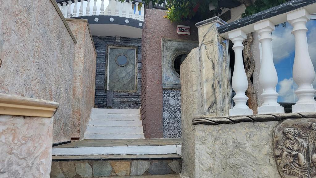 a stairway leading up to a building with a door at Korifi Apts & Std Adults Only in Hersonissos