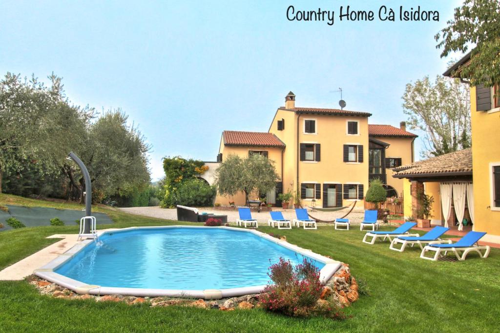 a pool in a yard with chairs and a house at Country Home CA' ISIDORA in Lazise