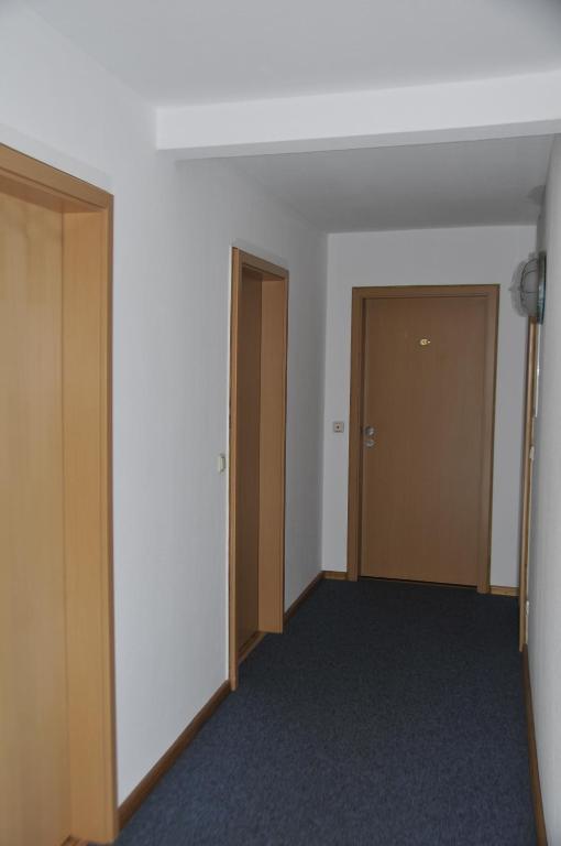 an empty room with two doors and a hallway at U-Nautic Restaurant &amp; Pension in Waren