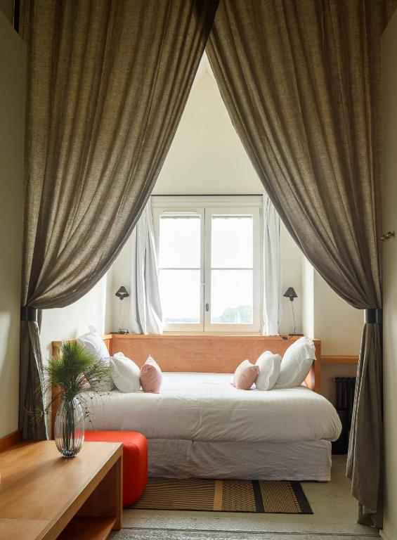 - une chambre avec deux lits en face d'une fenêtre dans l'établissement Le Bois des Chambres, à Chaumont-sur-Loire