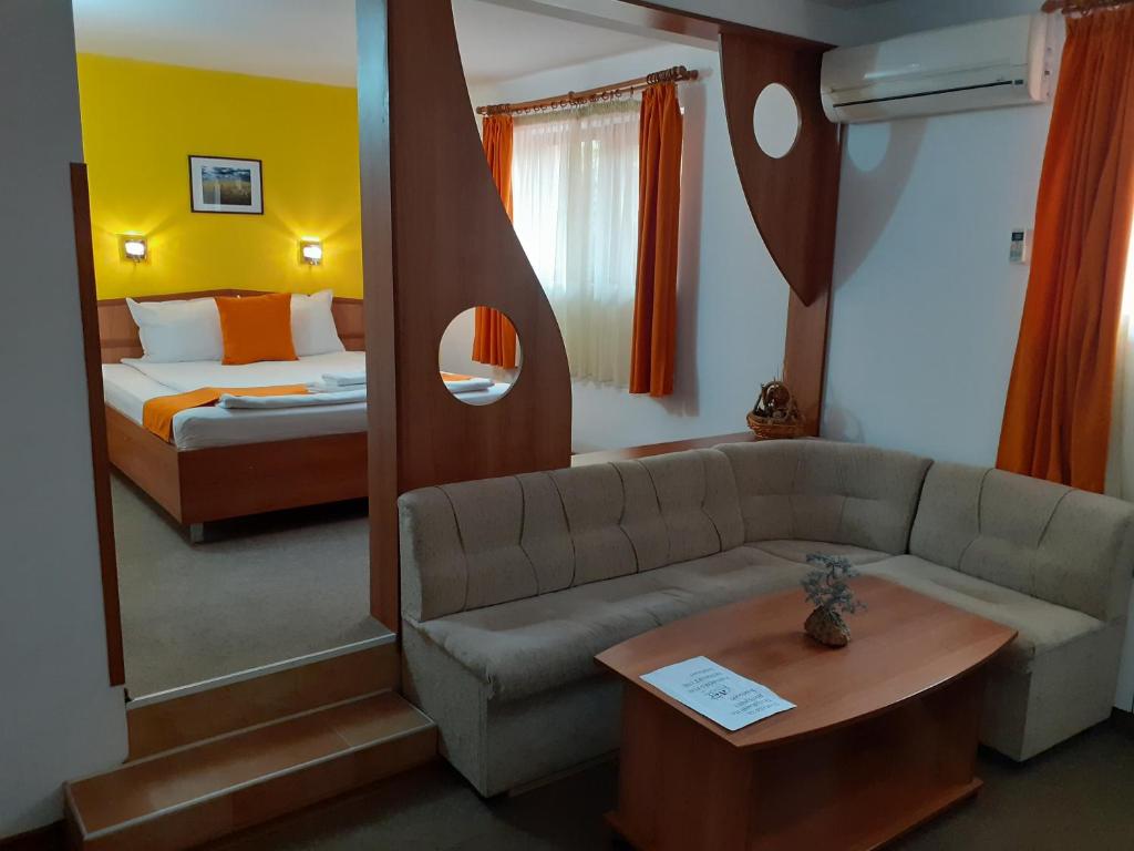 Hotel Les في Razgrad: غرفة معيشة مع أريكة وسرير