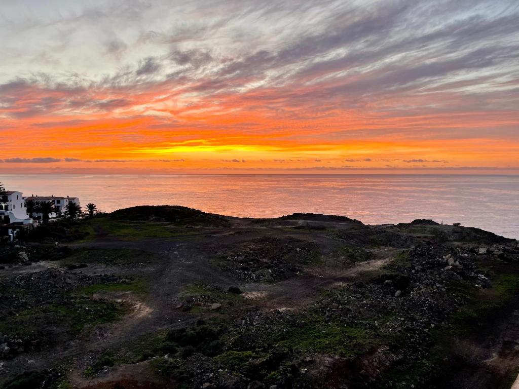 a sunset on top of a hill with the ocean at Balcon del Mar A&V Ocen View Costa del Silencio in Costa Del Silencio