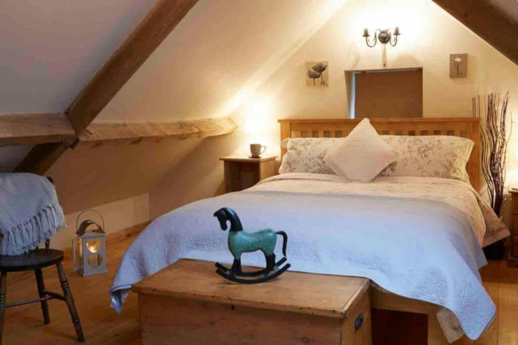 a bedroom with a bed with a duck statue on a chest at The Barn - Yorkshire Coast Holiday Lets in Whitby