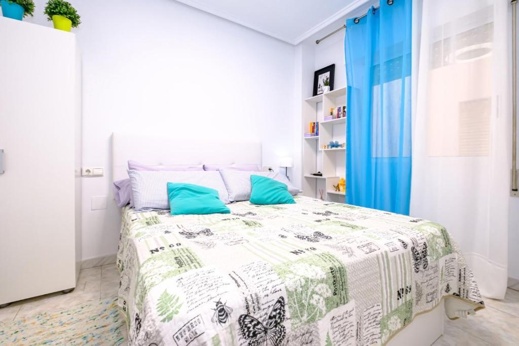 トレビエハにあるALEGRIA ID18の白いベッドルーム(青いカーテン付きのベッド1台付)