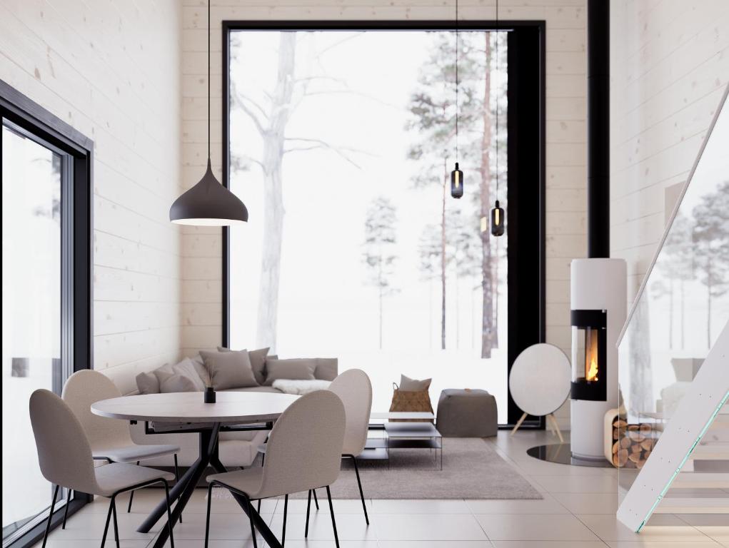 a white living room with a table and chairs at Polaris Villas in Muonio