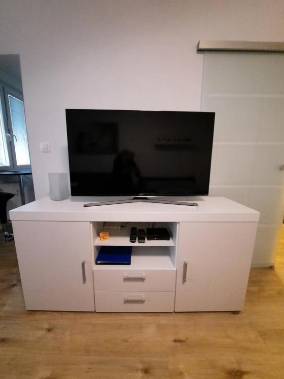 A television and/or entertainment centre at Apartment Klimka with balcony, free wifi and free parking