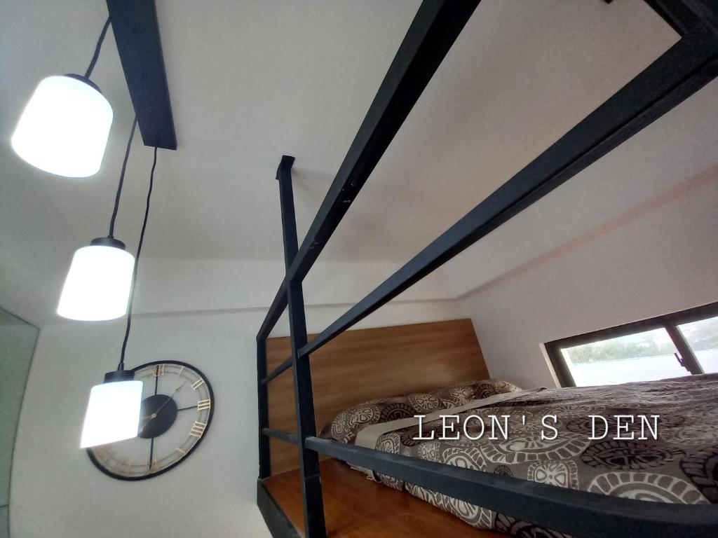 a bedroom with a bunk bed and two lights at Leon's Den in Baguio