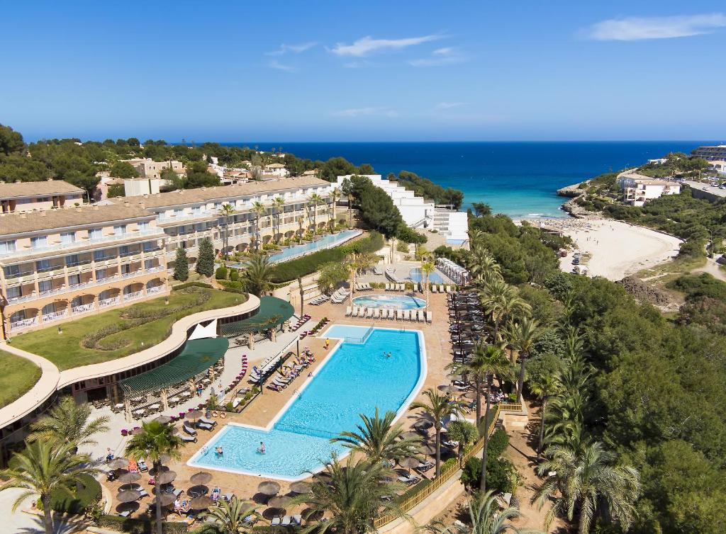 an aerial view of a resort with a pool and the beach at Insotel Cala Mandia Resort in Cala Mendia