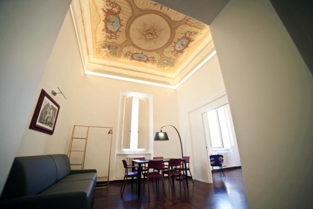 - un salon avec un plafond muni d'une table et de chaises dans l'établissement LUCIANO MONTI APARTMENT, à Rome