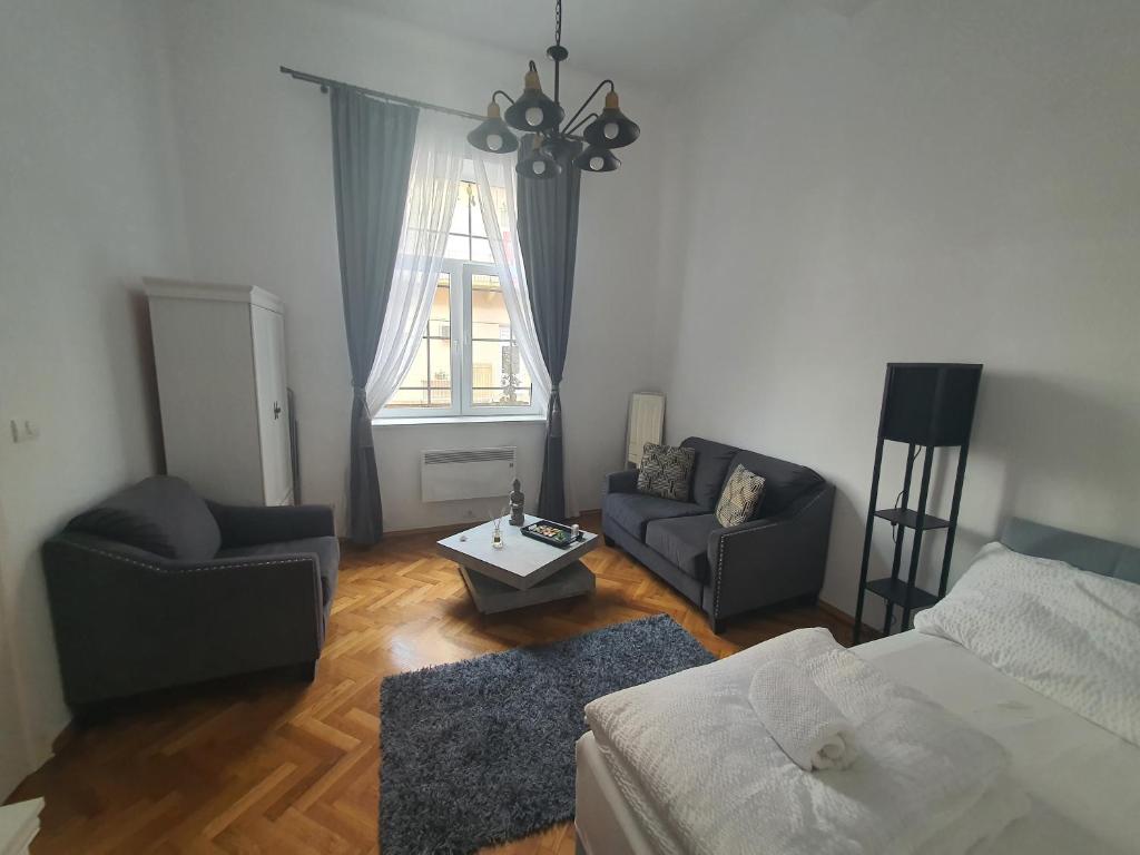 a living room with a bed couch and a window at ☆ Bulevard Apartments ☆ in Arad