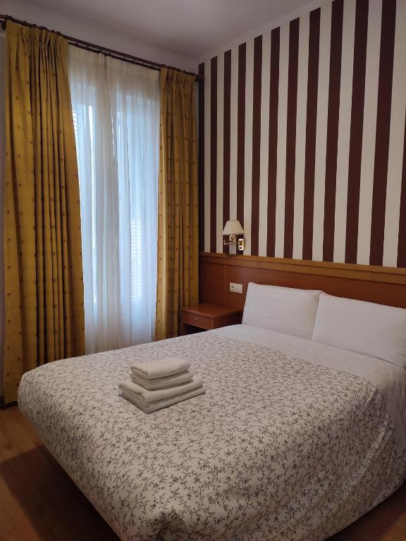 Postel nebo postele na pokoji v ubytování Hostal Salomé