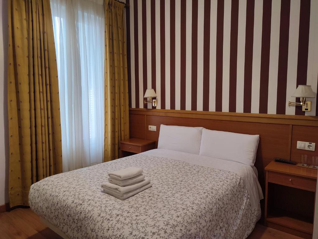 Postel nebo postele na pokoji v ubytování Hostal Salomé