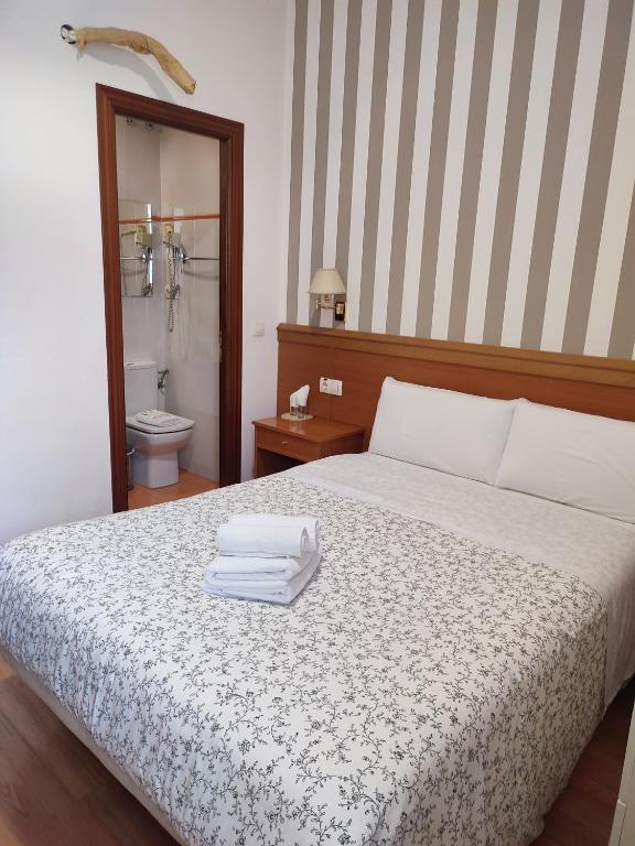 Postel nebo postele na pokoji v ubytování Hostal Salomé