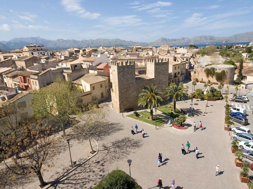 an aerial view of a city with buildings and people at Apartamentos Carlos V in Alcudia