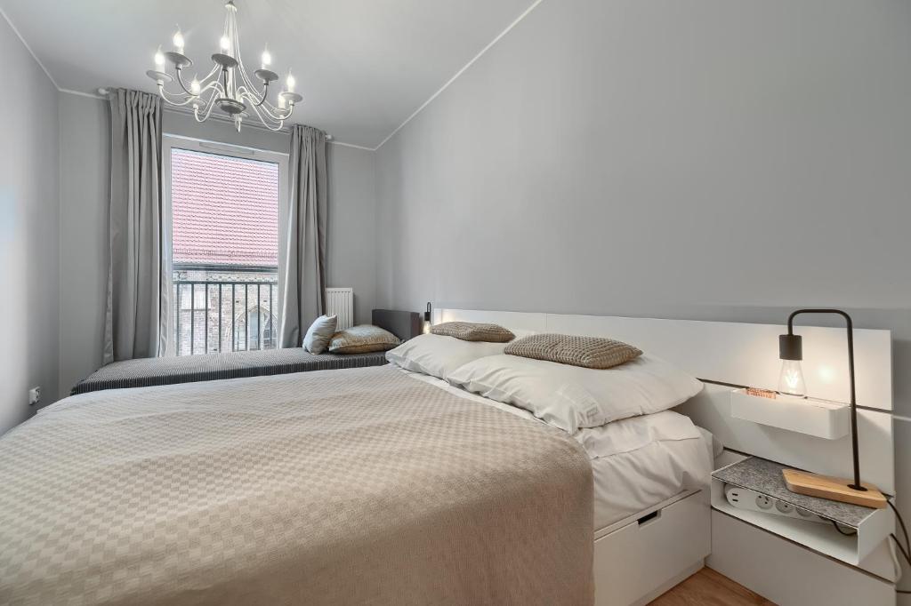 Posteľ alebo postele v izbe v ubytovaní Apartamenty MUNN 3 Szczecin