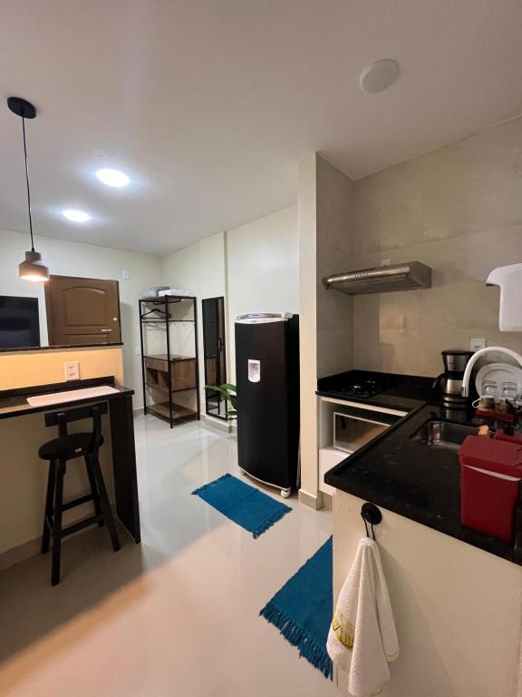 a kitchen with a black refrigerator and a counter at Loft 215 da Lapa, Rio de Janeiro in Rio de Janeiro